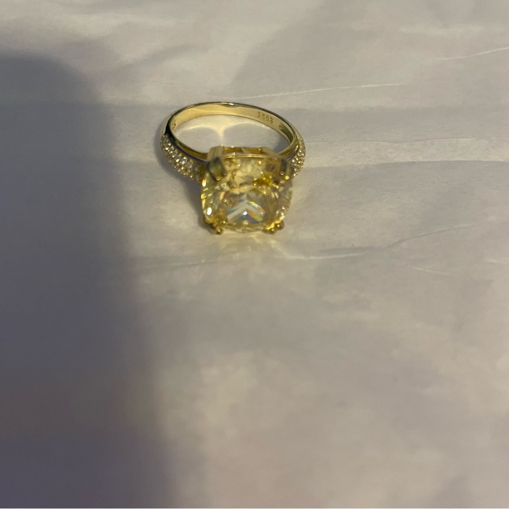 Gold tone ring with a yellow stone